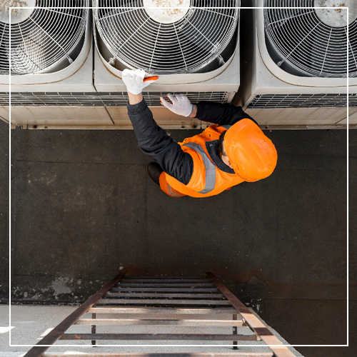 Woods Heating and Cooling HVAC contractor installing air conditioner in air conditioning and cooling services.