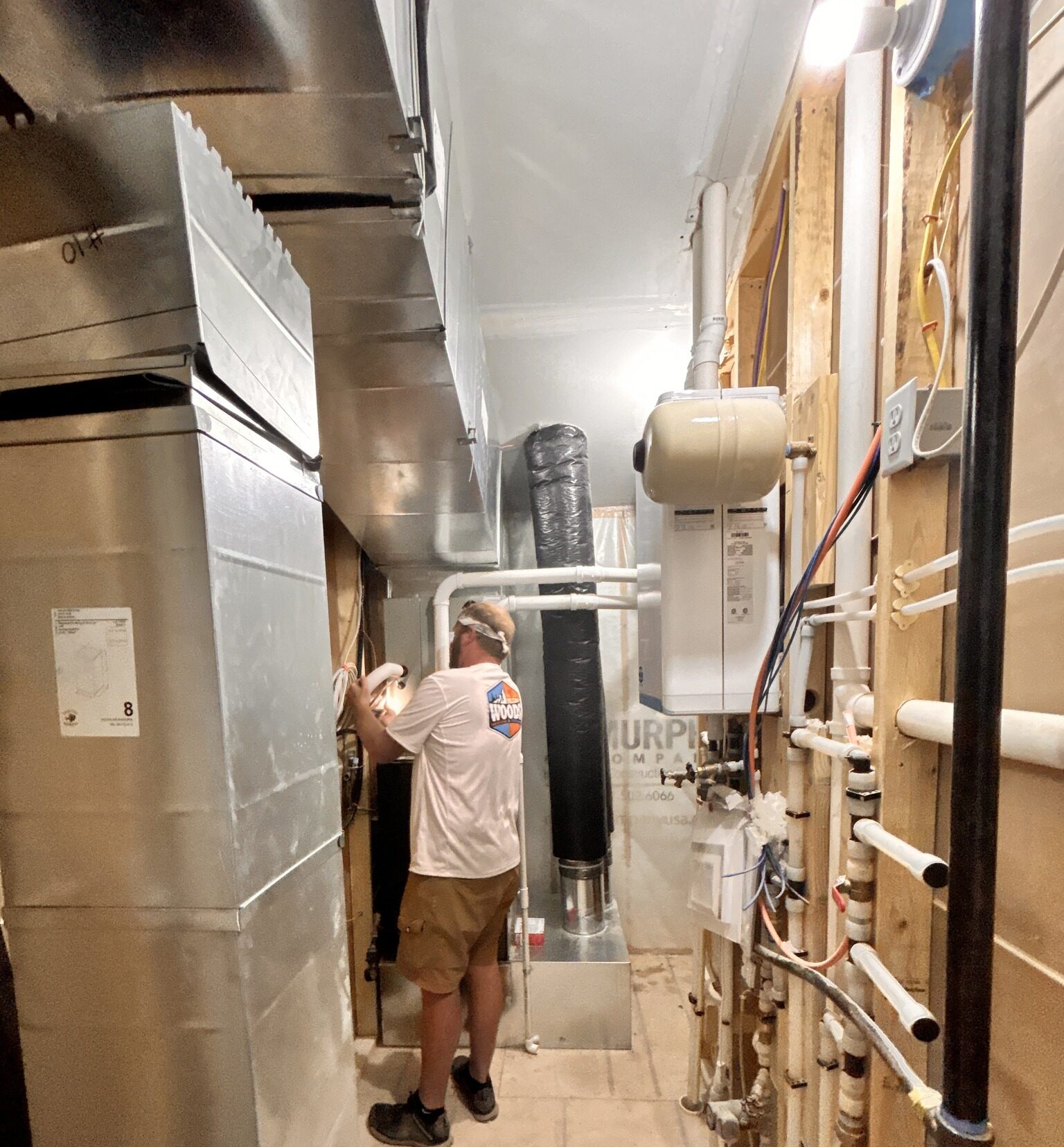 Technician performing residential furnace maintenance in a home in Spearfish, SD by Wood’s Heating & Cooling.