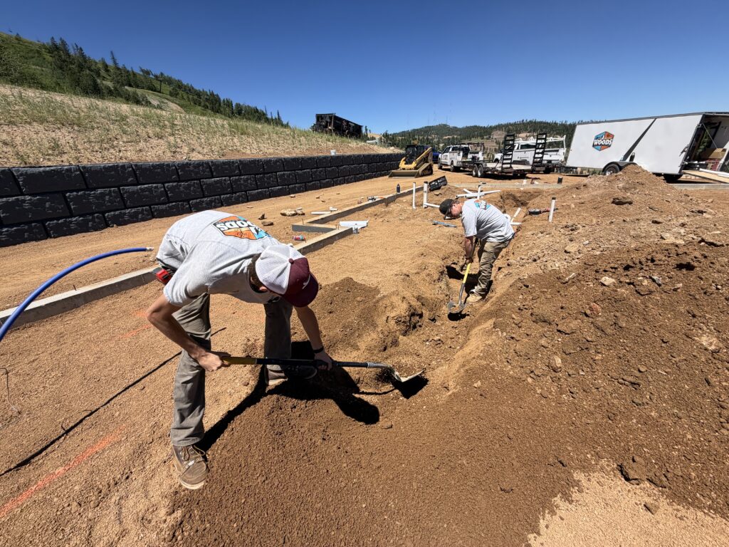 Woods Heating and Cooling crew trenching for underground plumbing and HVAC rough-in at a new home in Deer Mountain Village, Lead, SD.