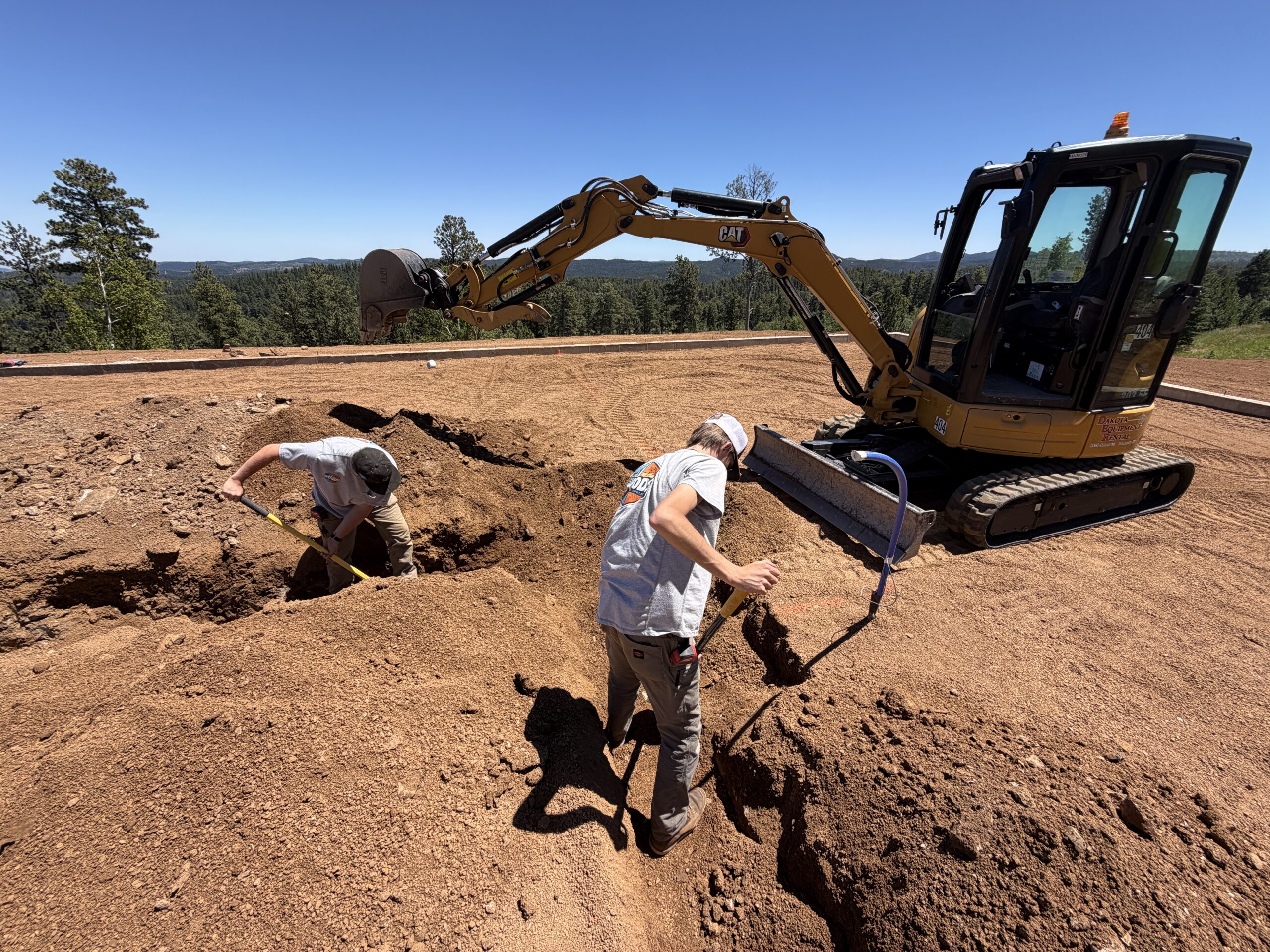 Woods Heating and Cooling crew digging trench for custom home project in Deer Mountain Village near Lead, SD.