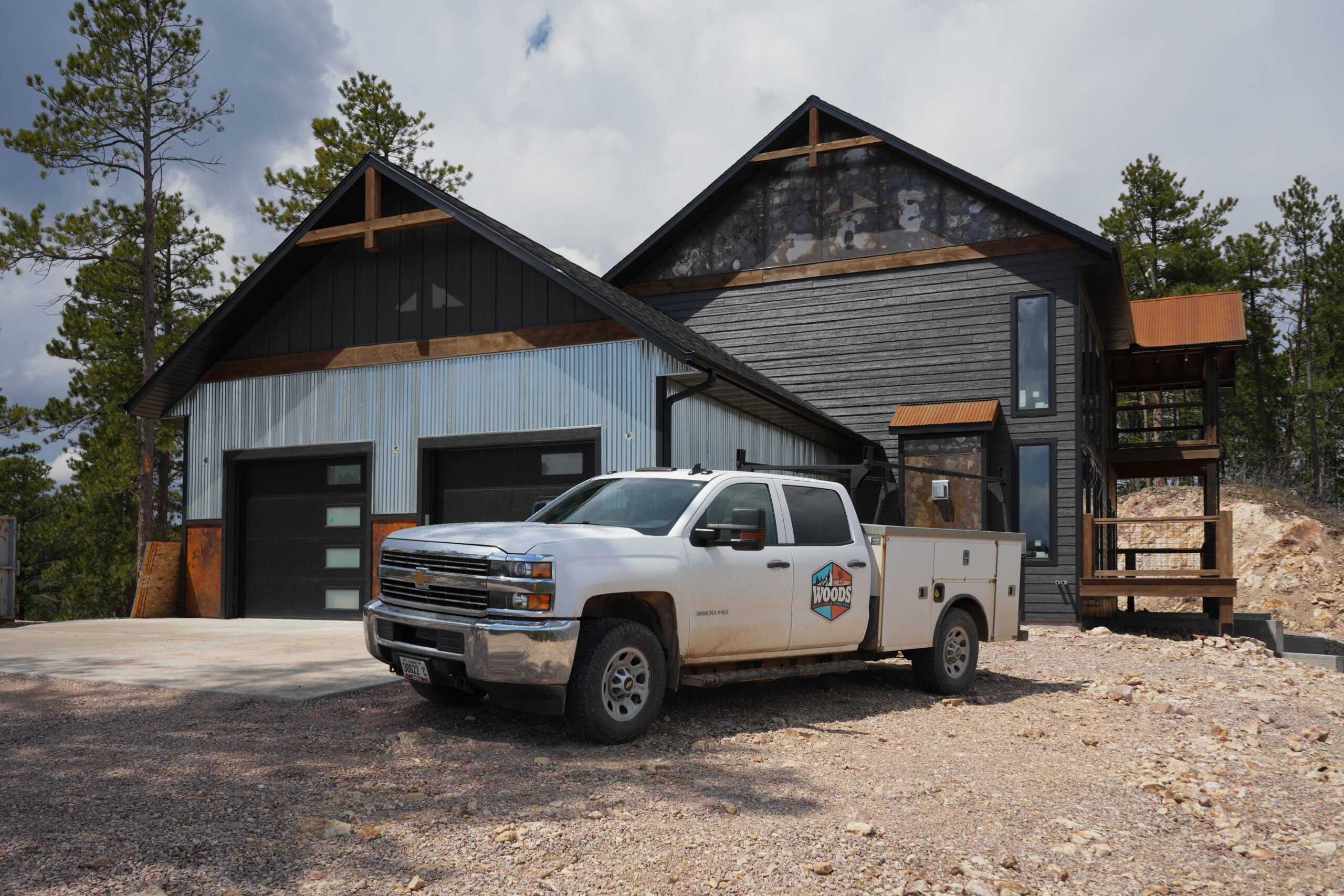 Woods Heating & Cooling Truck in front of jobsite for HVAC Services for New Construction HVAC Services in Spearfish, SD.
