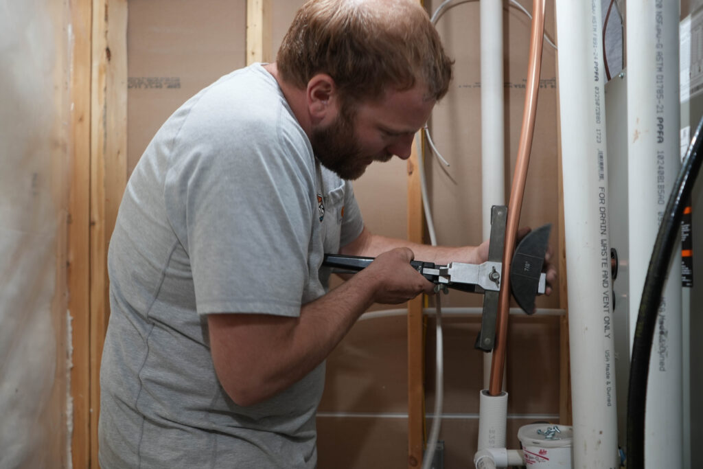 Wood’s Heating & Cooling technician performing AC repair services on a home system in Spearfish, South Dakota.