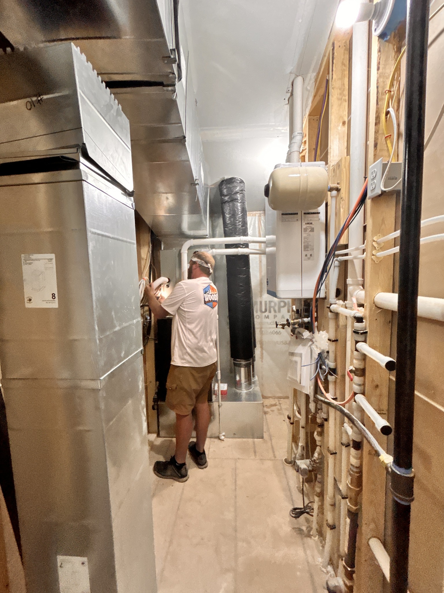 Technician performing residential furnace maintenance in a home in Spearfish, SD by Wood’s Heating & Cooling.